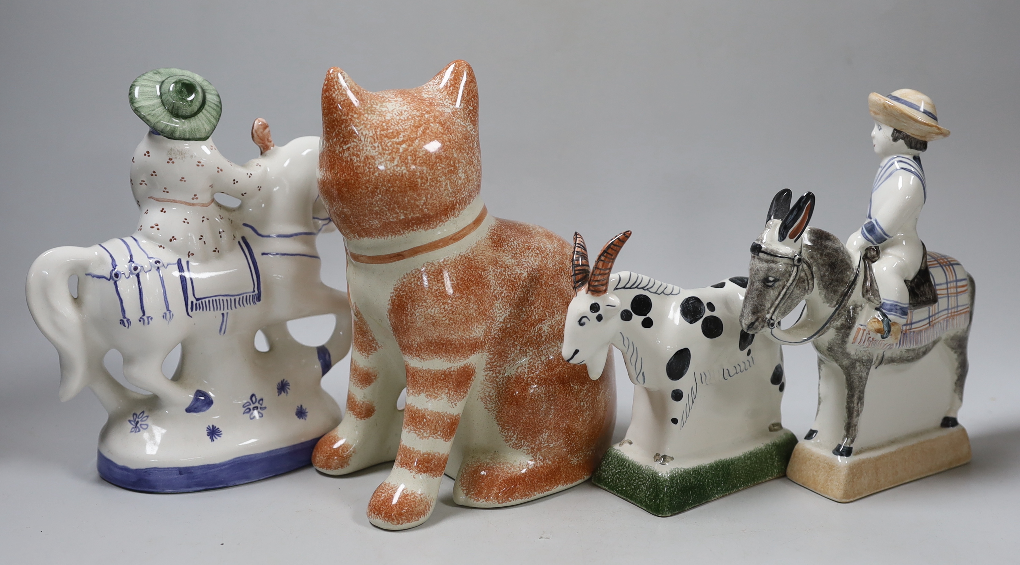 A Rye pottery Billy the goat, a boy riding a donkey, a lady on horseback and a cat, 20cm high (4)